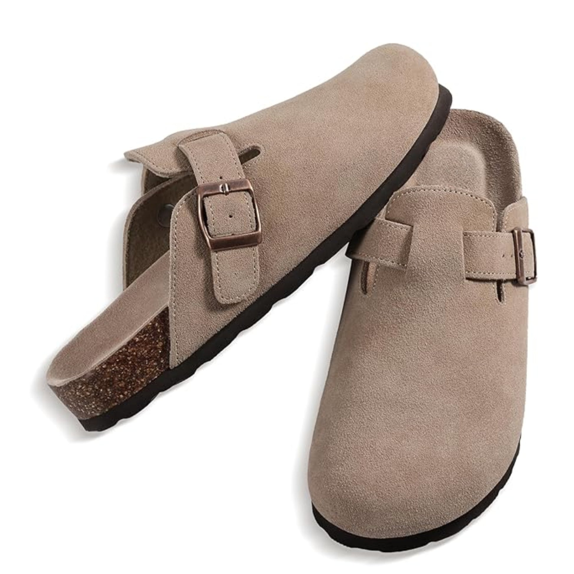 Pair of beige suede clogs with buckle straps on a white background