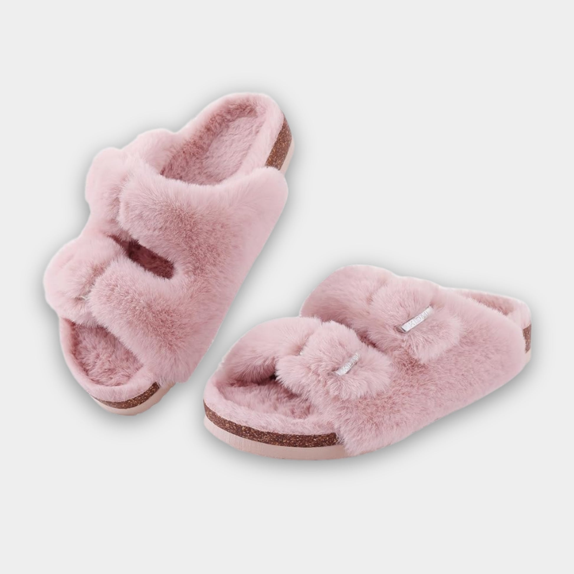 Pair of pink fuzzy slippers on a light gray background