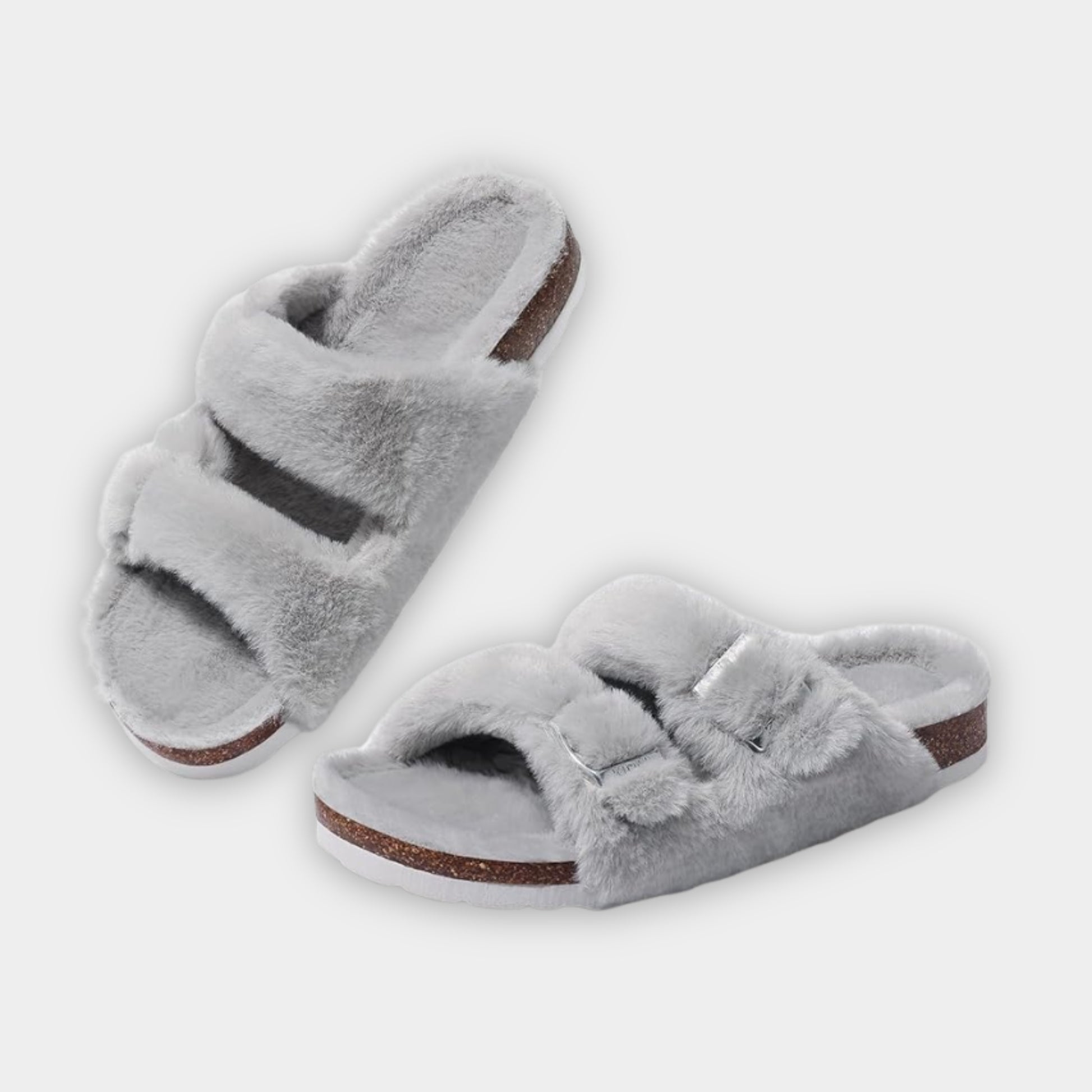 Pair of gray fuzzy slippers on a white background