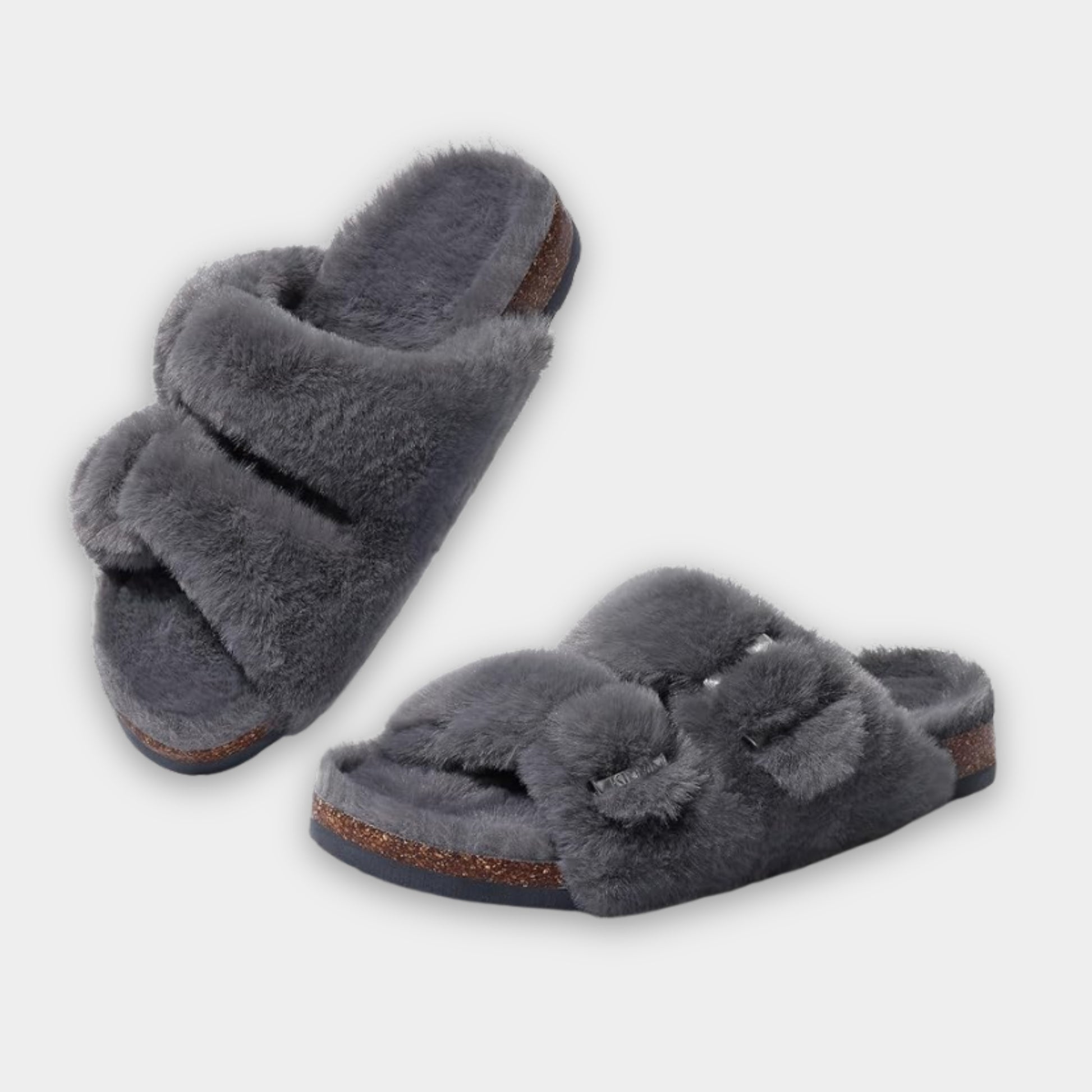 Pair of gray fuzzy slippers on a light gray background