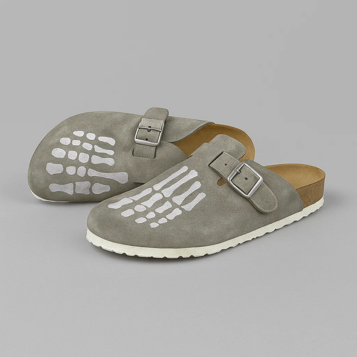 Pair of gray sandals with buckles on a gray background