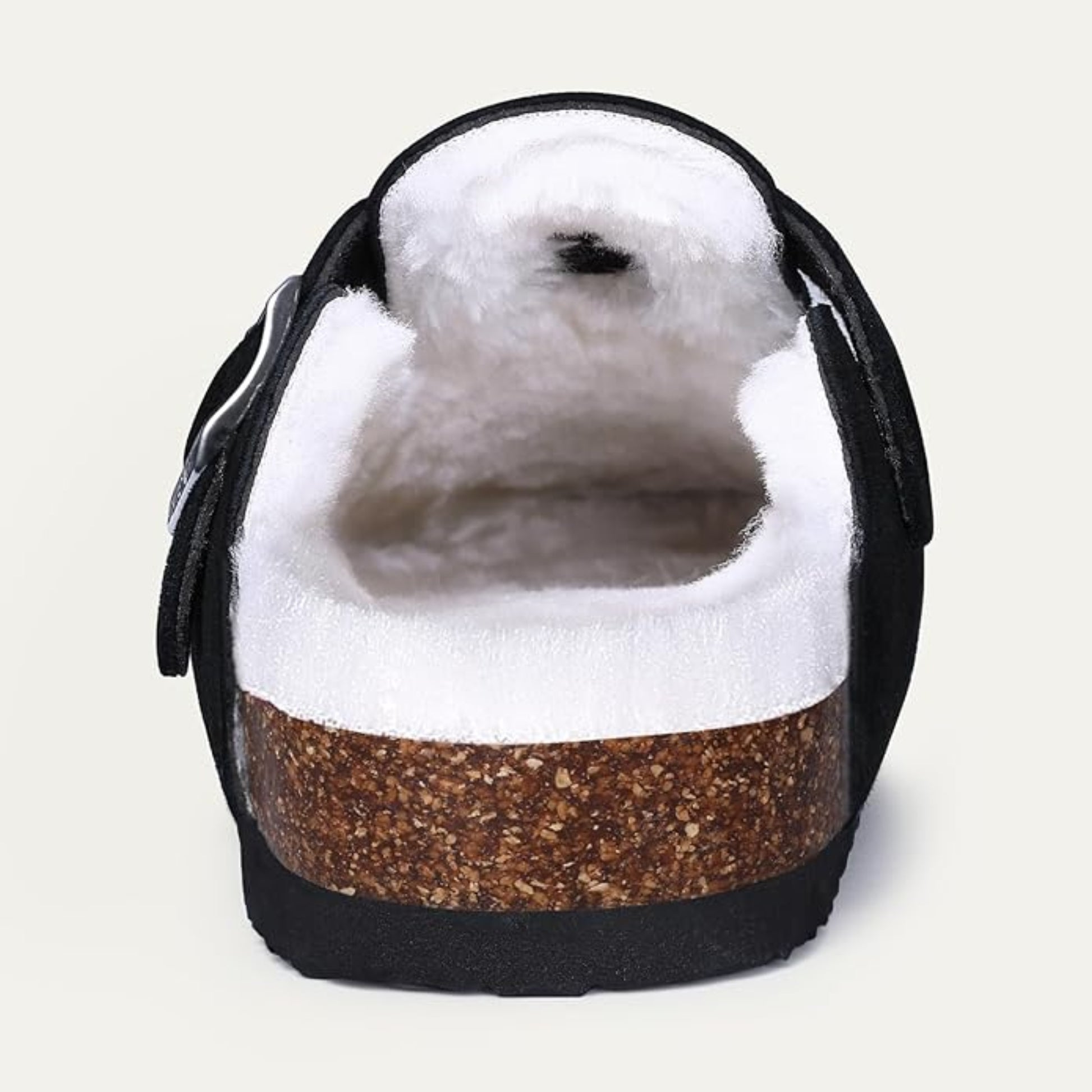 Cute seal plush toy inside a black and brown shoe on a light gray background